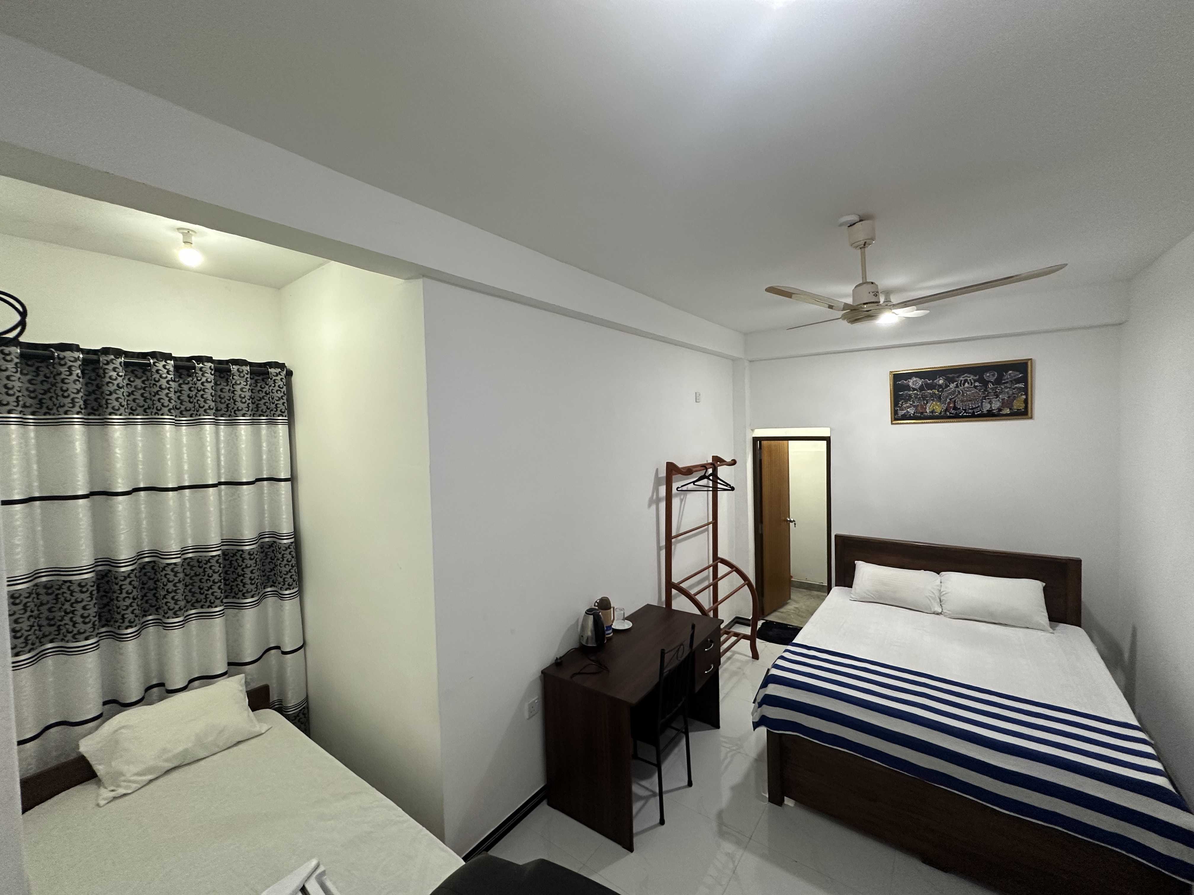 Two Double Rooms with a single bed and a double bed at White House Galaha